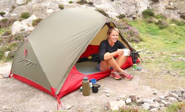 Woman sitting in tent with coffee