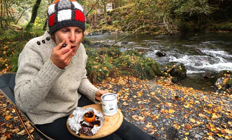 Woman eating orange campfire cake