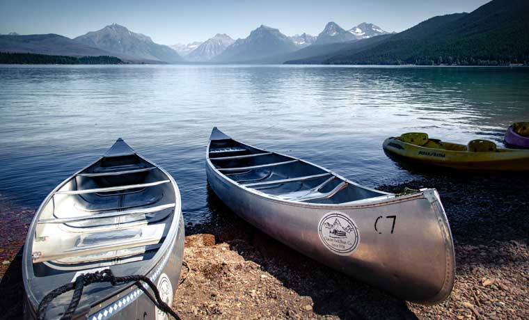 Canoes on lake with mountains