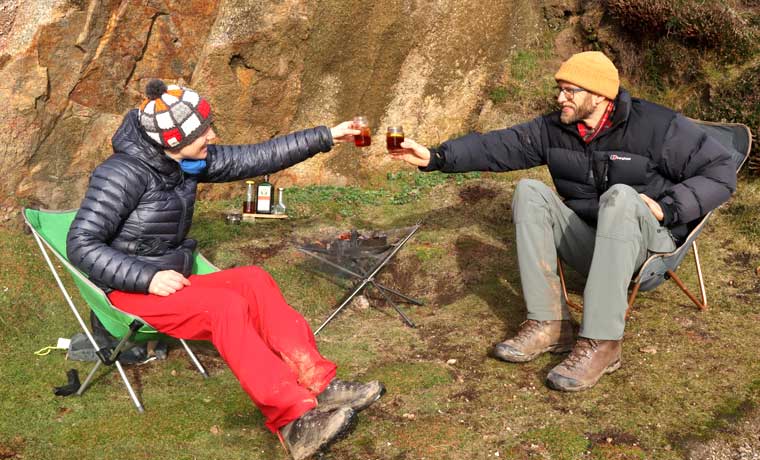 Couple toasting with a campfire cocktail