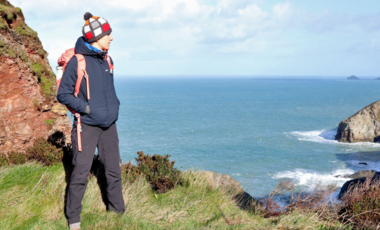 Woman looking out to sea wearing Finisterre Jacket