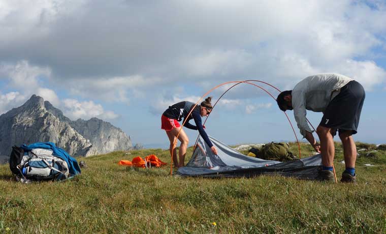 Couple putting up tent