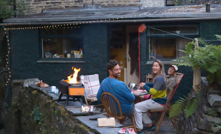 People sitting around a firepit on the patio