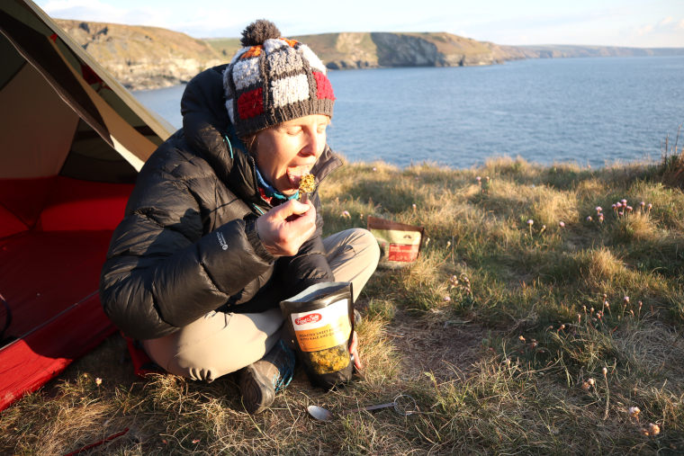 Woman eating freeze dried backpacking food