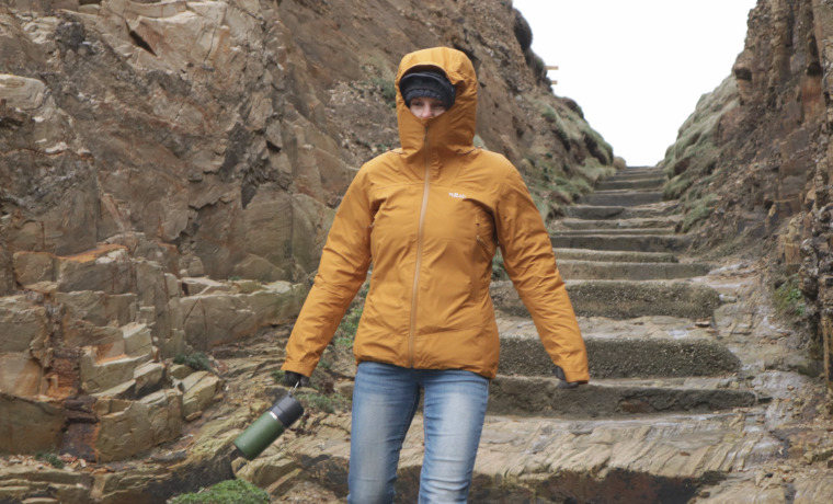 Woman walking in orange rain jacket