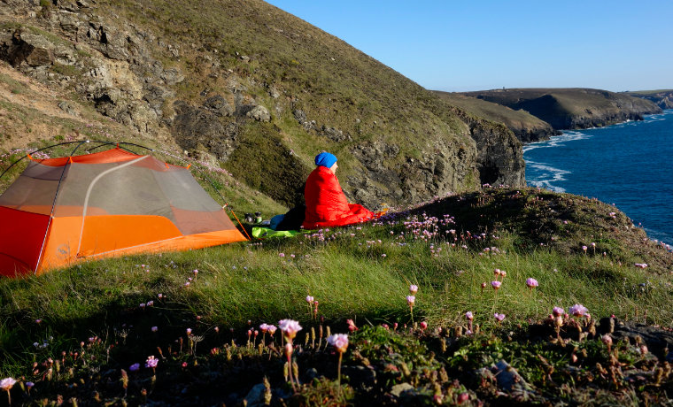 Woman camping alone on cliffs