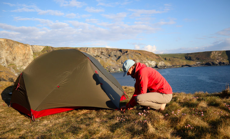 Woman putting up a tent
