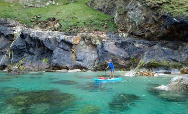 Woman paddle boarding in Cornwall