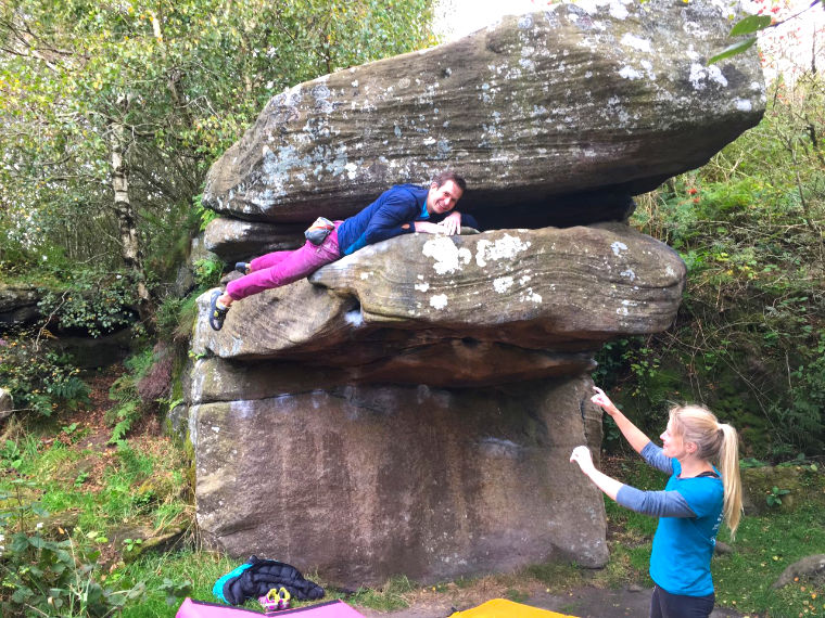 Man topping out of bouldering problem