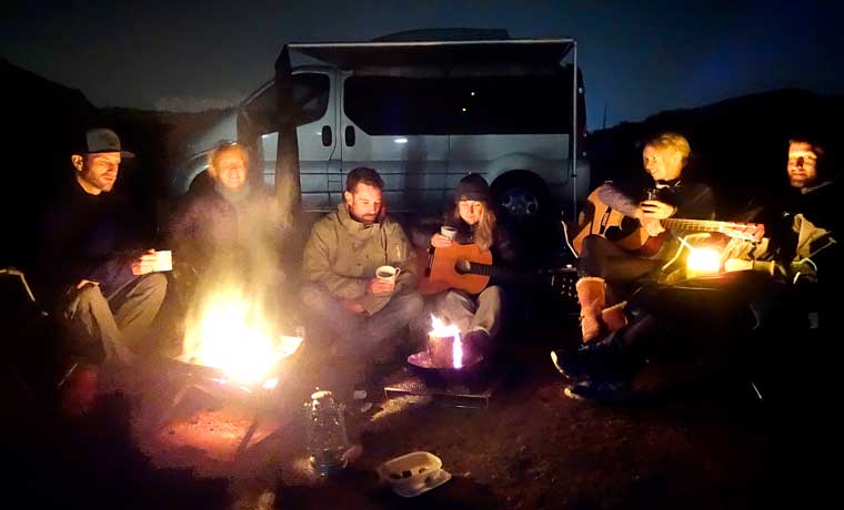 People-sitting-around-campfire
