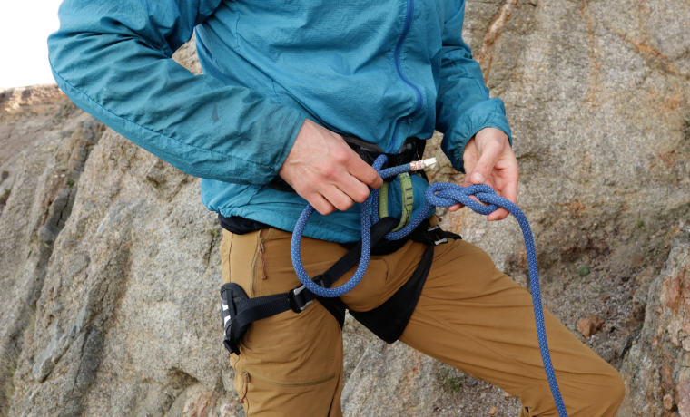 Climber feeding rope through harness