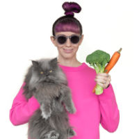 Woman holding cat and veggies