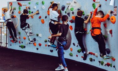 Kids playing climbing games on indoor wall