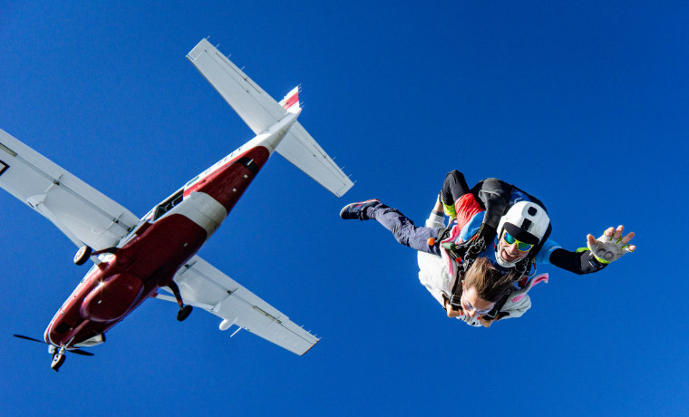 Skydivers and plane in the sky