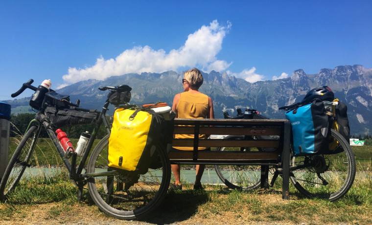 Woman-sitting-on-bench-with-bikes