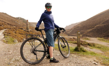 Rab Cinder Jacket and shorts on female cyclist