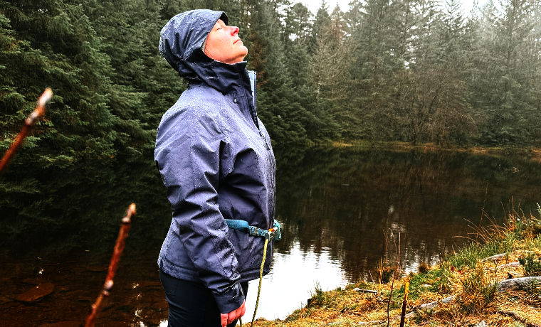 Woman wearing jacket by lake